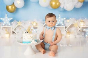Winter wonderland themed setup with white and gold balloons and twinkling lights.