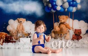 Dreamy cloud-like setup with blue balloons and white cotton backdrop.