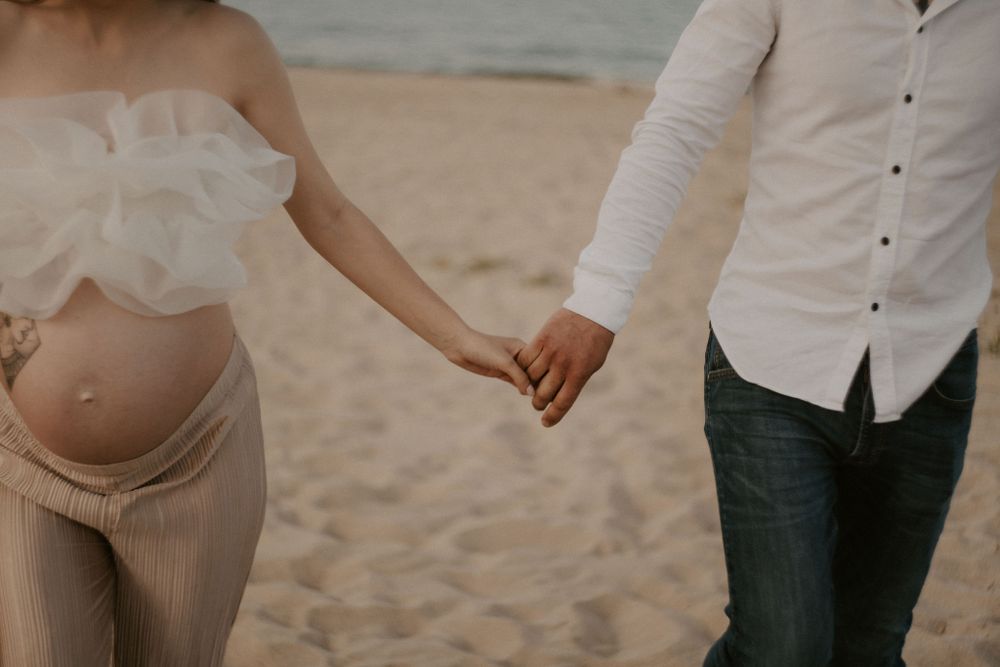 Intimate beach portraits showing loving moments between a couple.