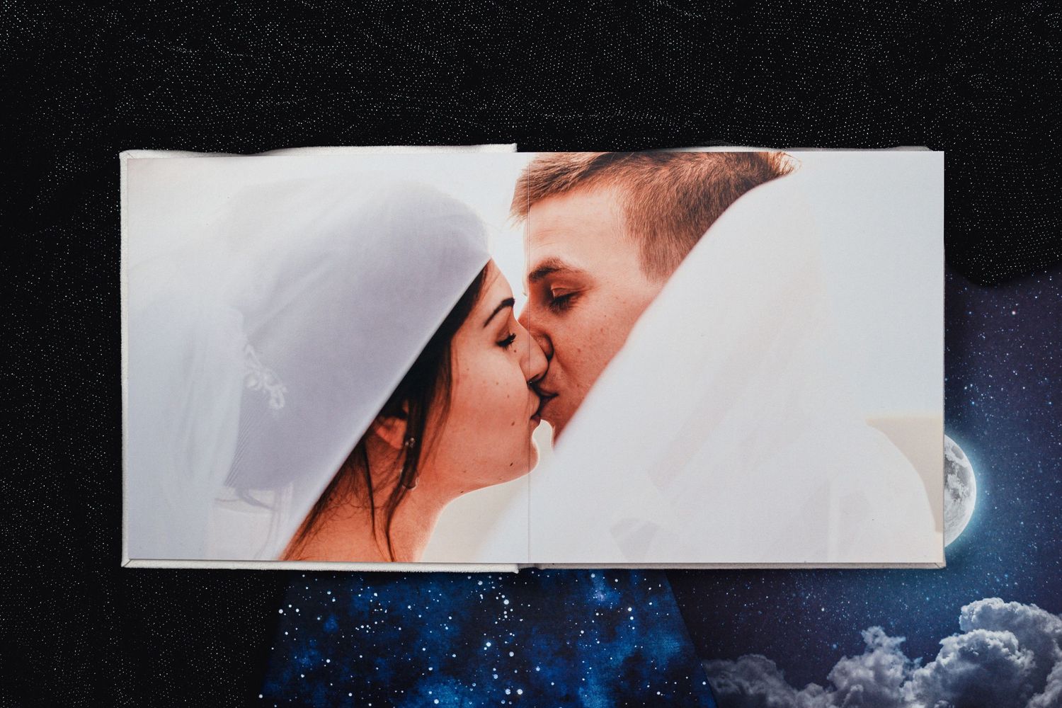 Artistic wedding photo album layout with starry night sky background.
