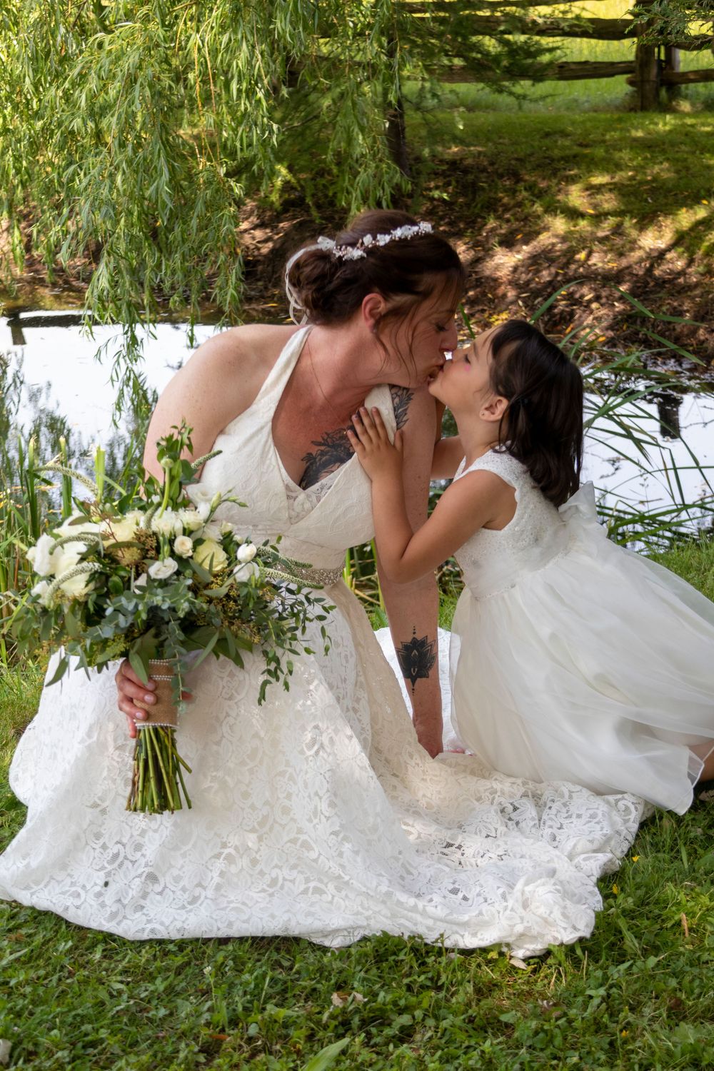 Flower girl kissing the bride