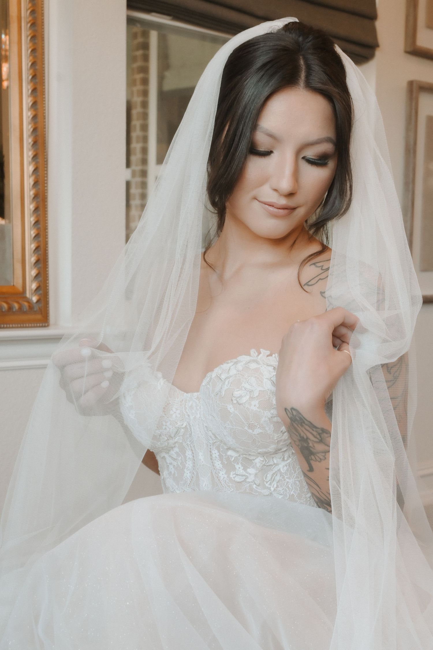 Romantic bridal portraits featuring an intricate lace wedding gown and flowing veil.