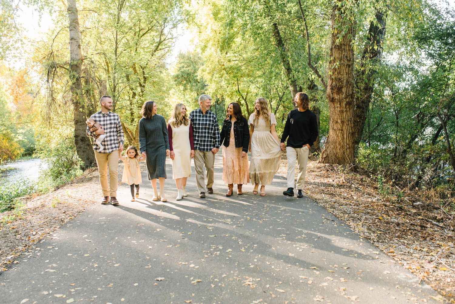 Group walking together on tree-lined path during autumn.