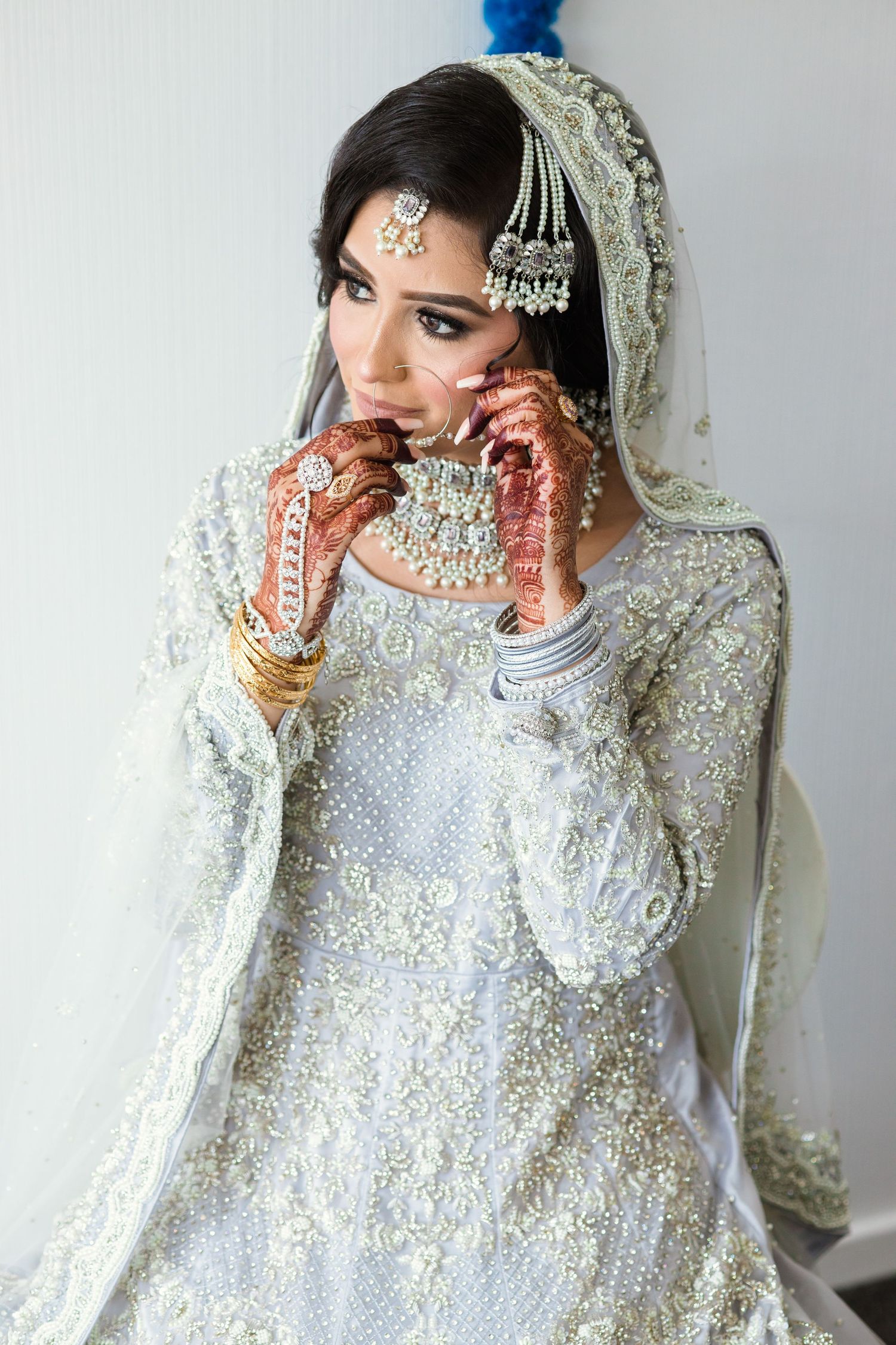 Beautiful Sikh woman adjusting her expensive silver nose ring.