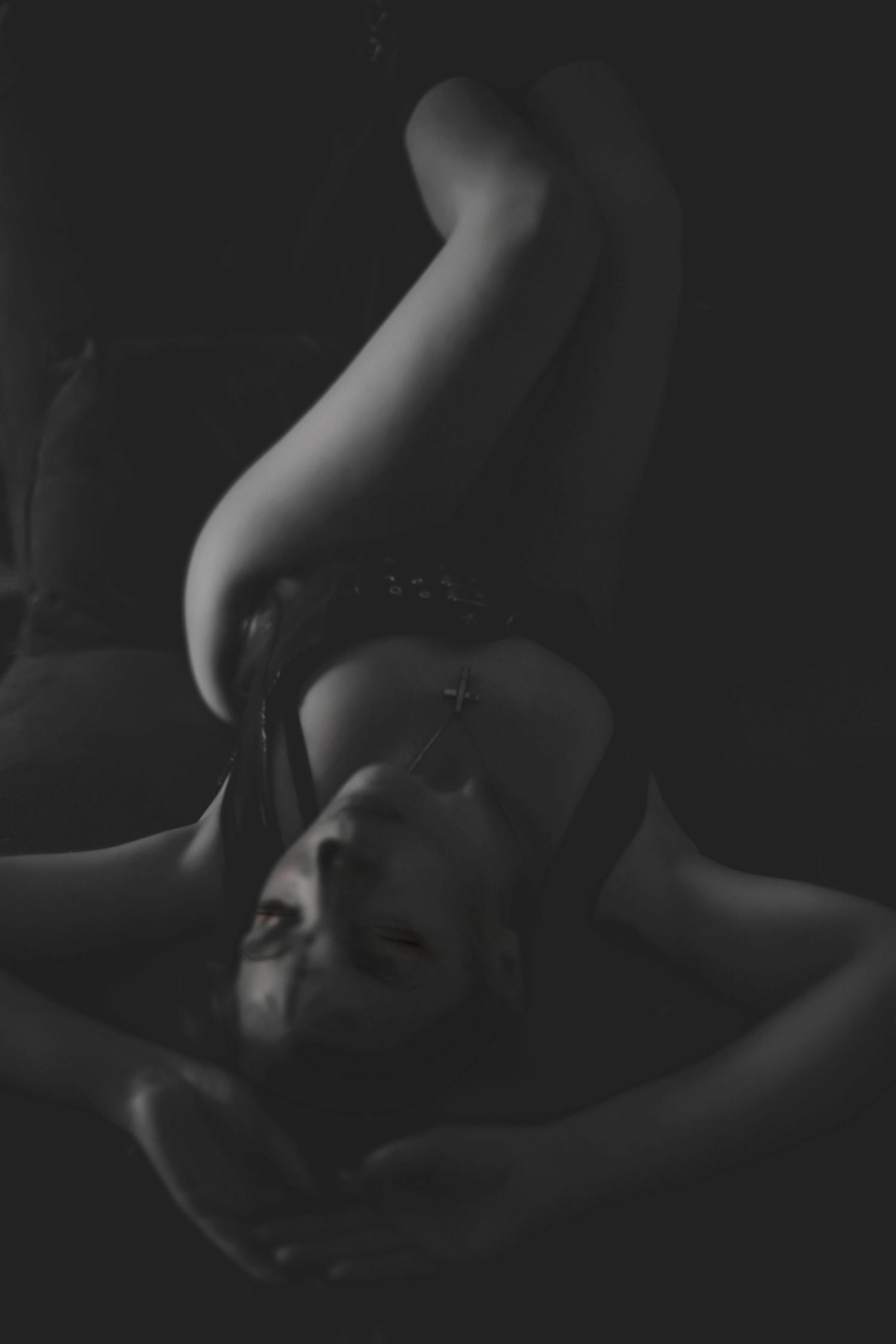 Artistic black and white portrait in dramatic lighting and shadow.