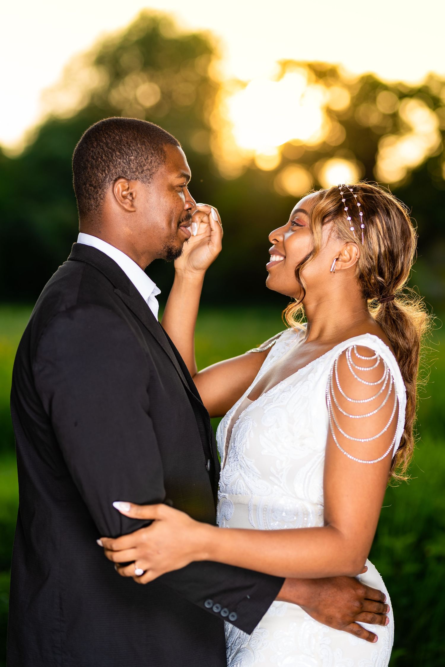Bride and groom embracing and sharing a moment in the sunset