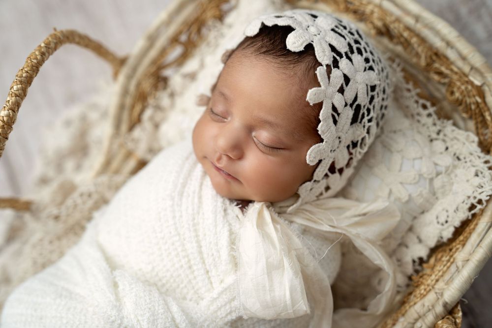 Vintage-inspired newborn portraits with lace details and cream tones.