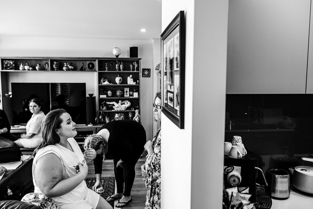 Black and white photograph of people gathered in a kitchen or dining area.