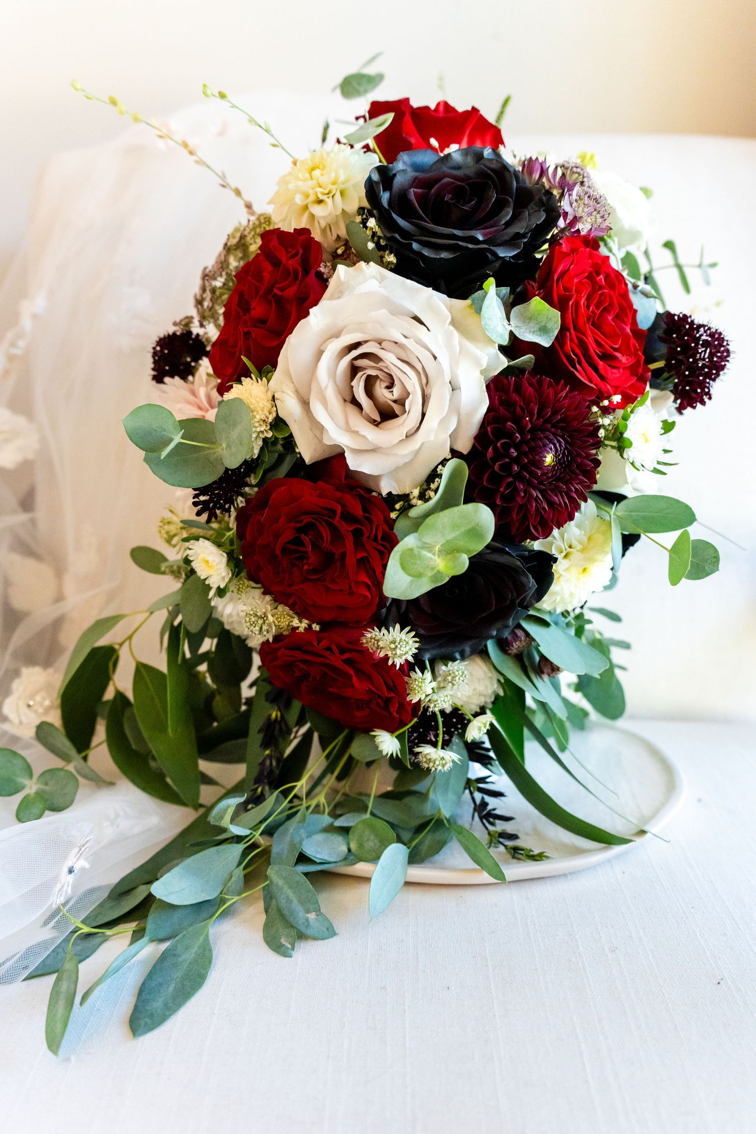 bride's bouquet with black, burgundy, and white roses