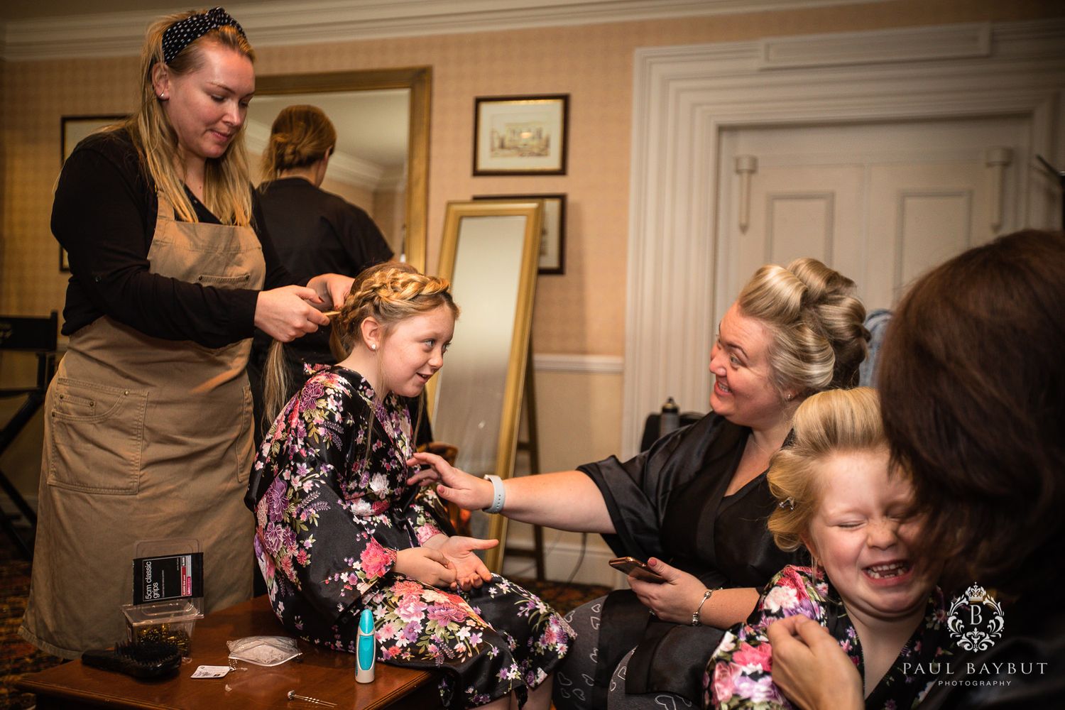 Wedding preparation scene showing getting ready moments in an elegant room with vintage decor.