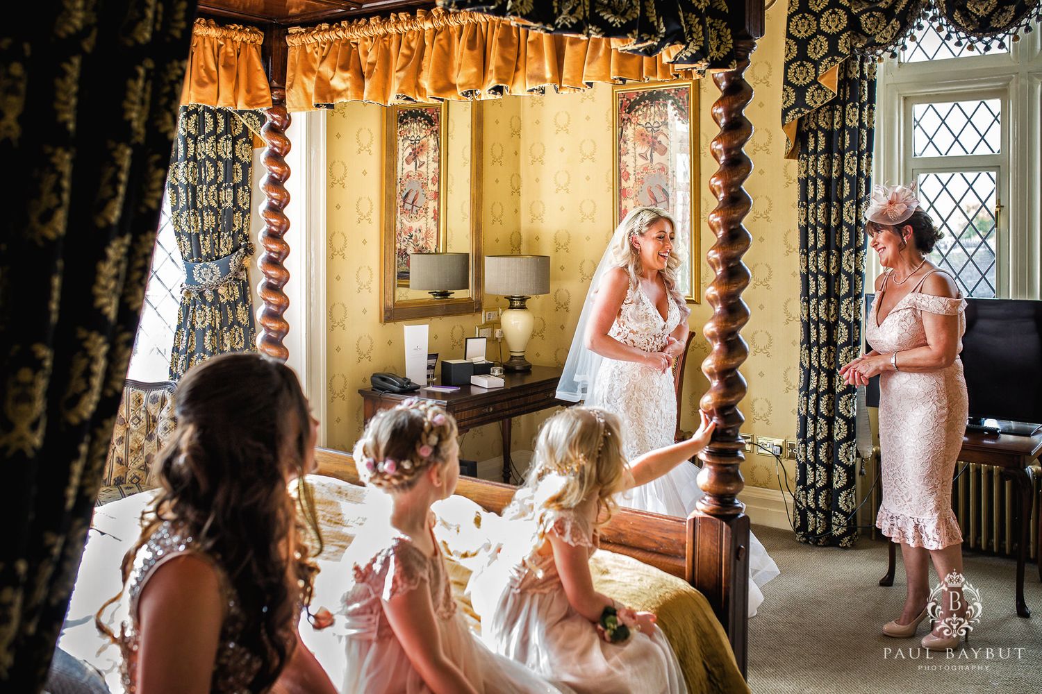 Wedding preparation scene in an ornate room with draped windows and vintage decor.