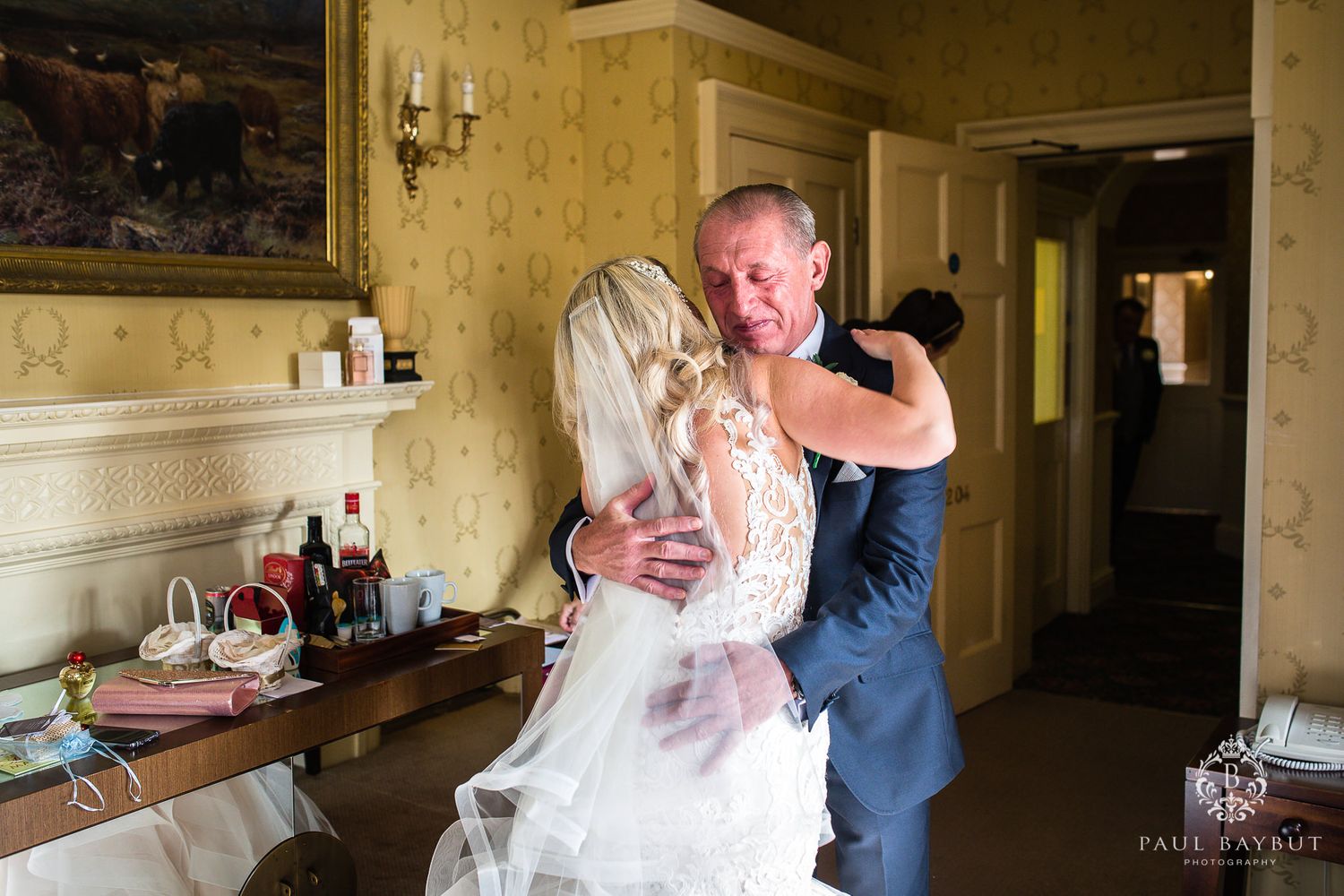 Intimate wedding moment captured in a traditionally decorated room.