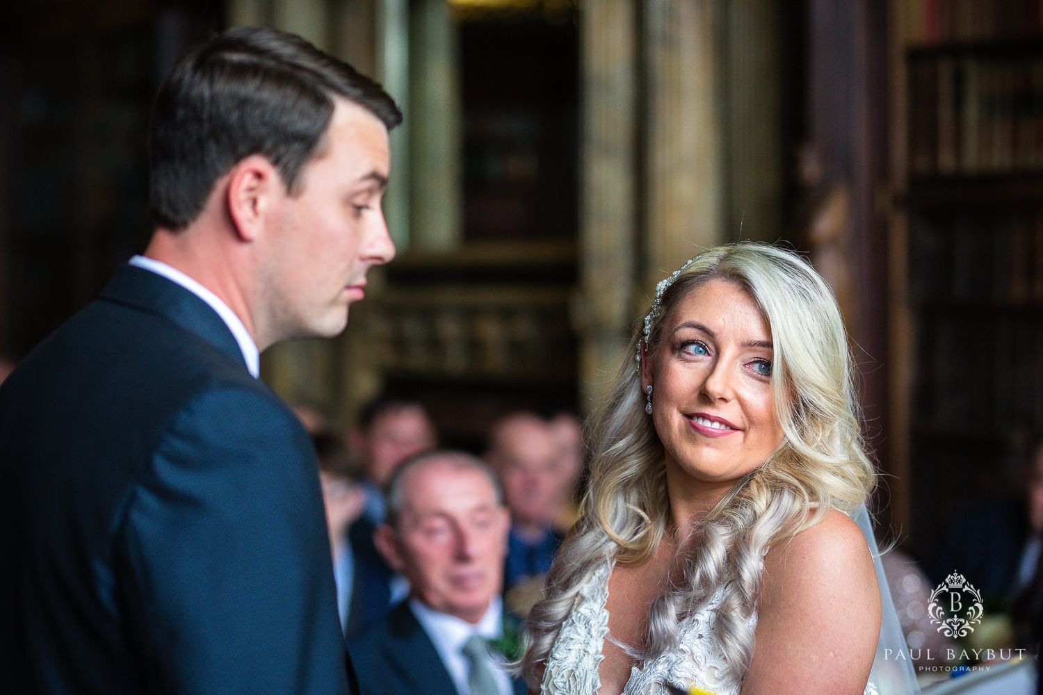A couple shares a joyful moment during their library wedding ceremony.