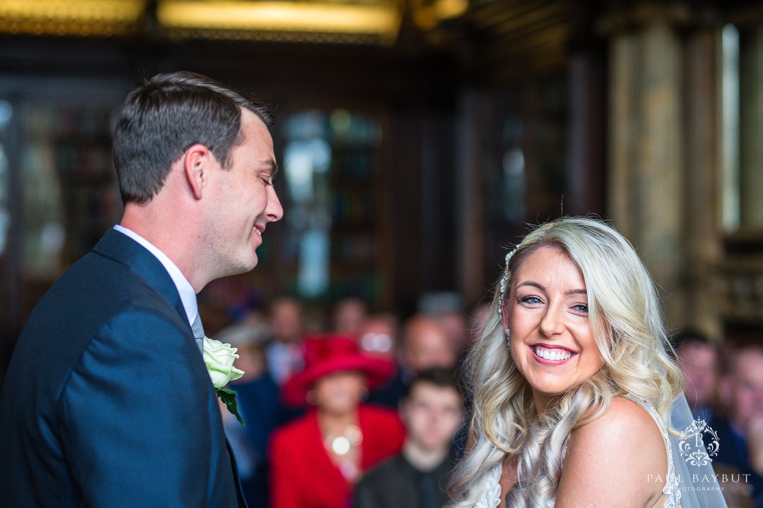 A joyful couple exchanges happy glances during their wedding ceremony.