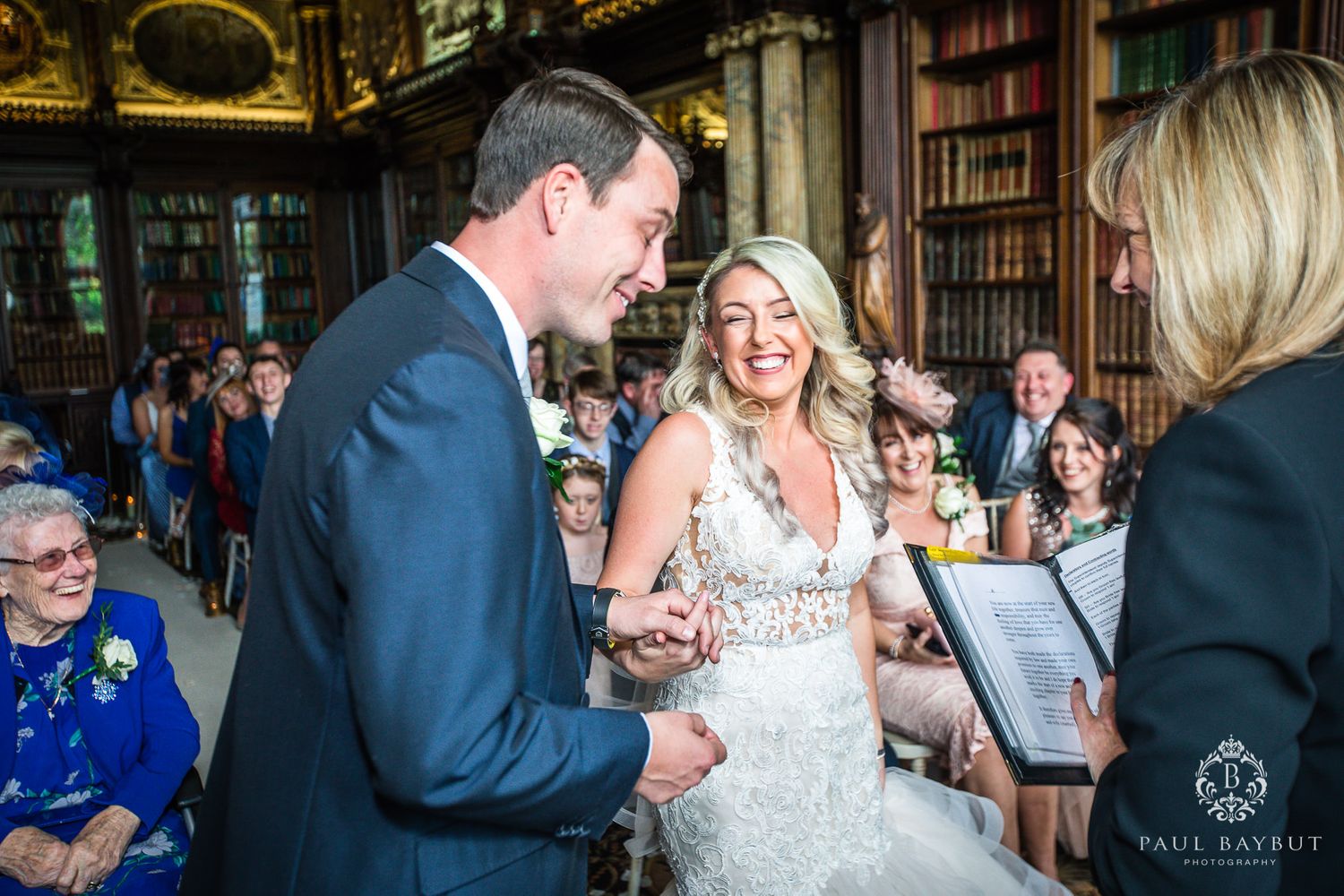 Candid moment during library wedding ceremony with laughter and joy.