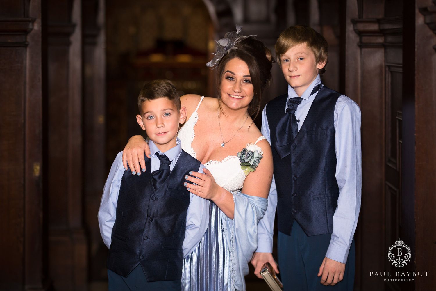 Formal group portrait in an elegant hallway with ornate architectural details.