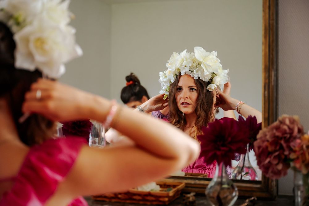 Elegant wedding preparations with white floral arrangements and delicate details in warm lighting.