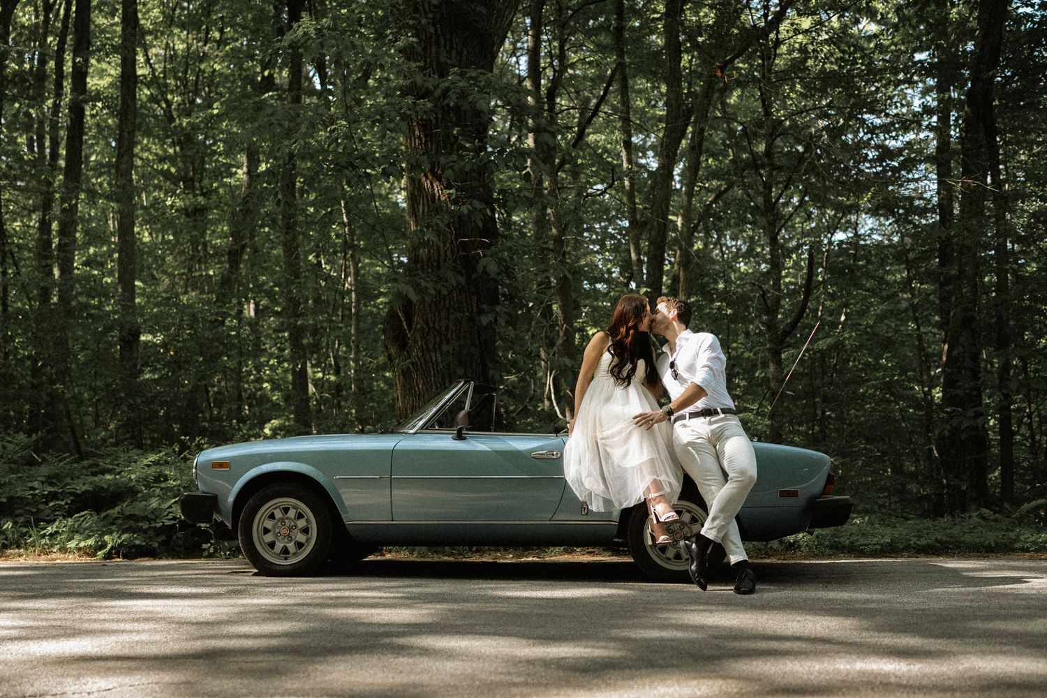Couple sitting on vintage car engagement session