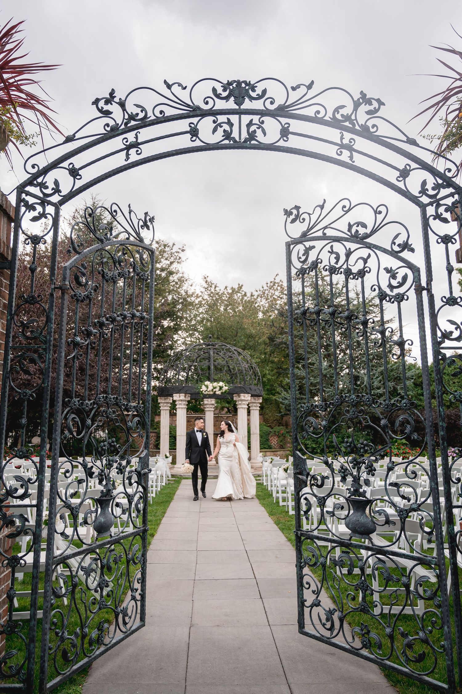 The couple walks hand in hand at The Inn at New Hyde Park.