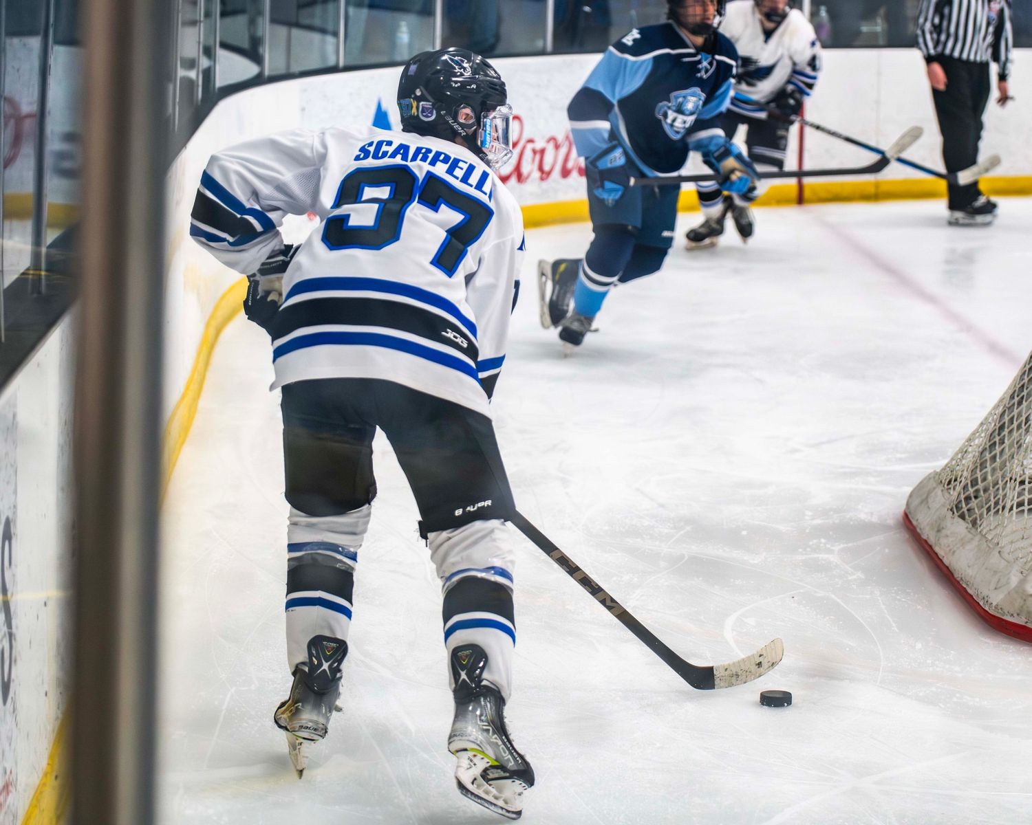 Ice hockey players battling for the puck during an intense game.