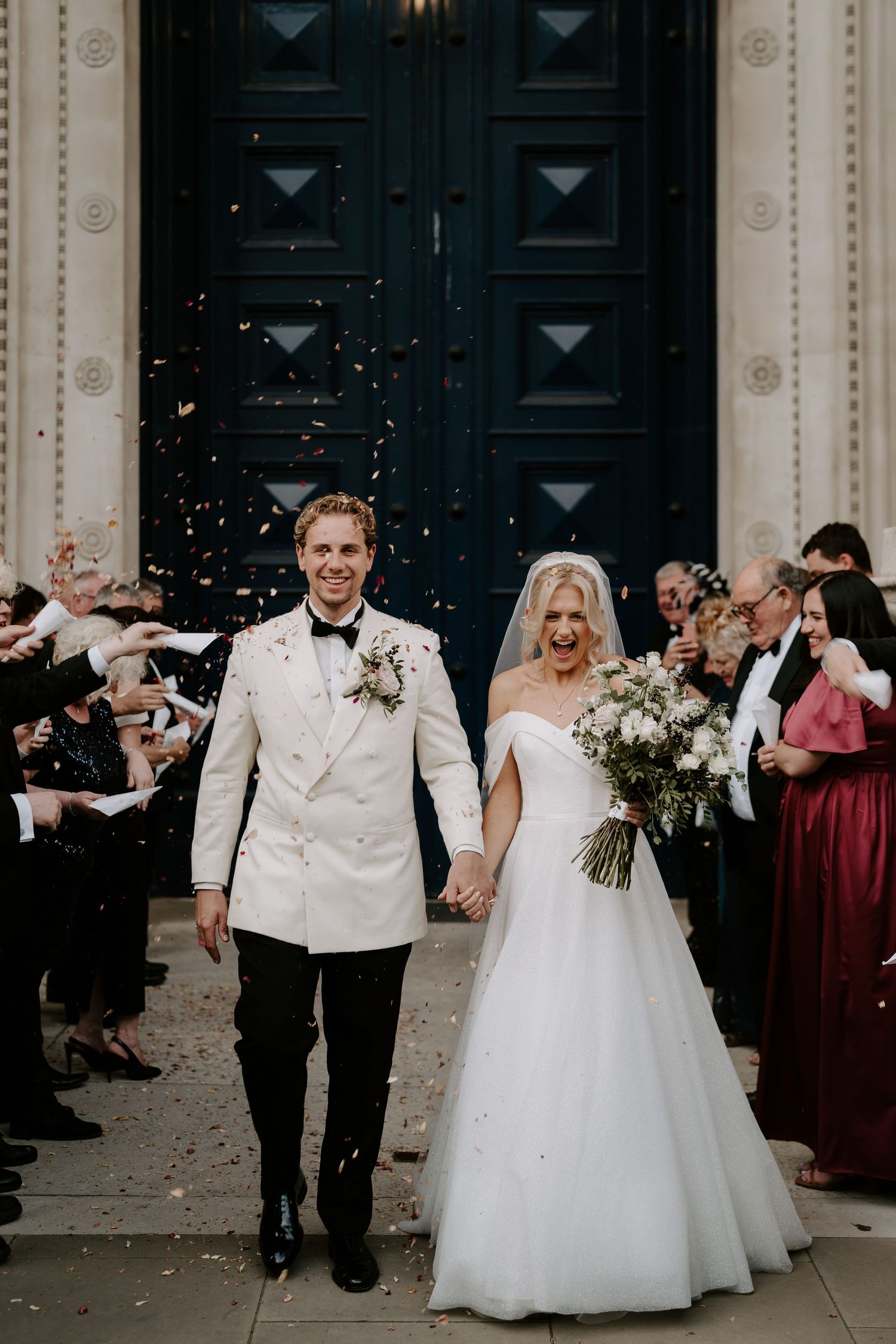 confetti being thrown over bride and groom as they leave the Ashmolean Museum
