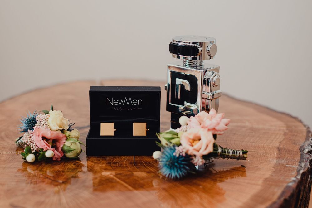 Wedding decor items and name cards displayed on a rustic wooden surface.