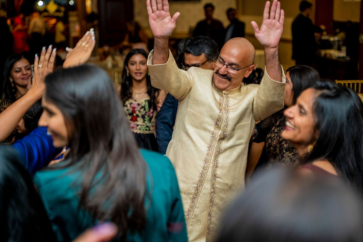 Enthusiastic dancing and celebration at a festive indoor gathering.