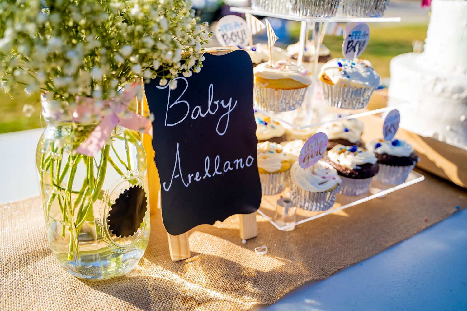 Baby shower dessert table with rustic decor and chalkboard signage.