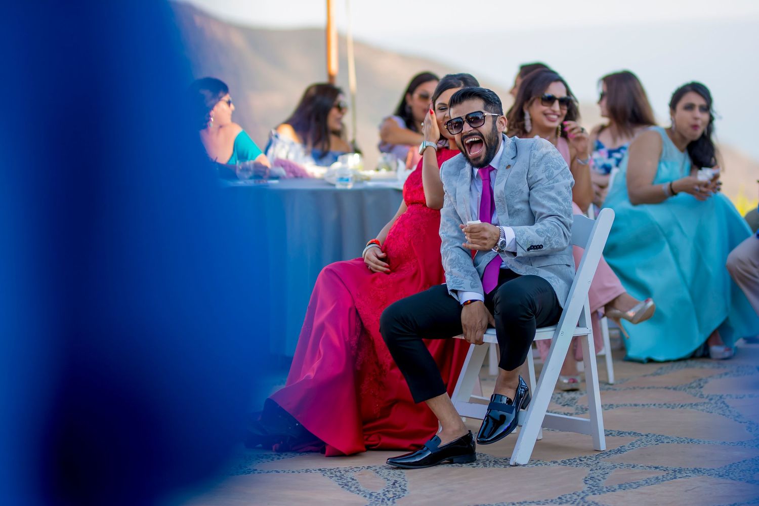 Party guests seated at outdoor tables during a celebration.