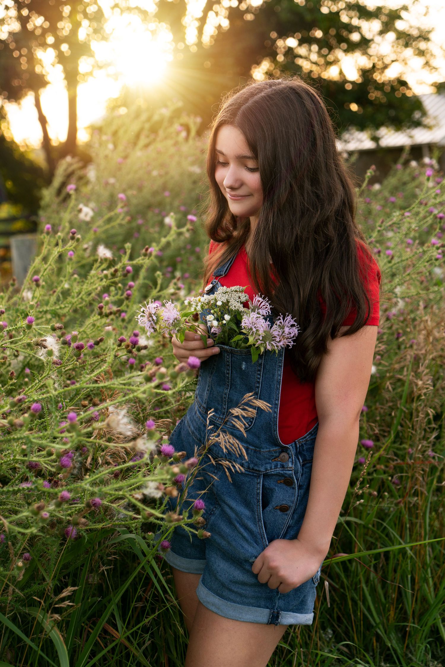 girl looks at wildflowers