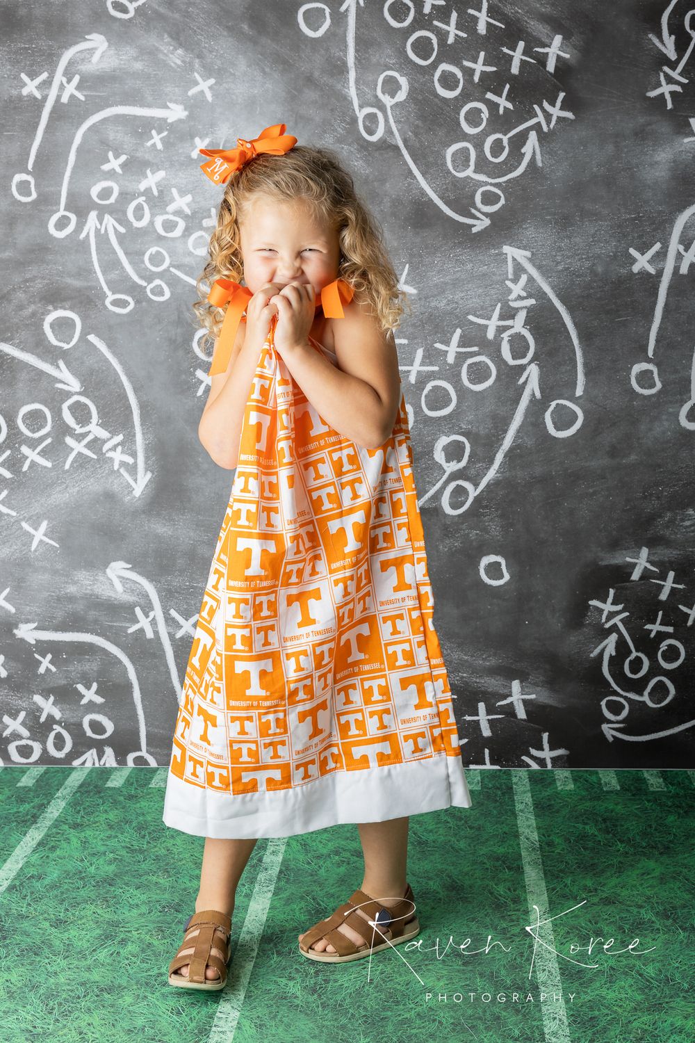 Girl in University of Tennessee dress posing for football themed portraits