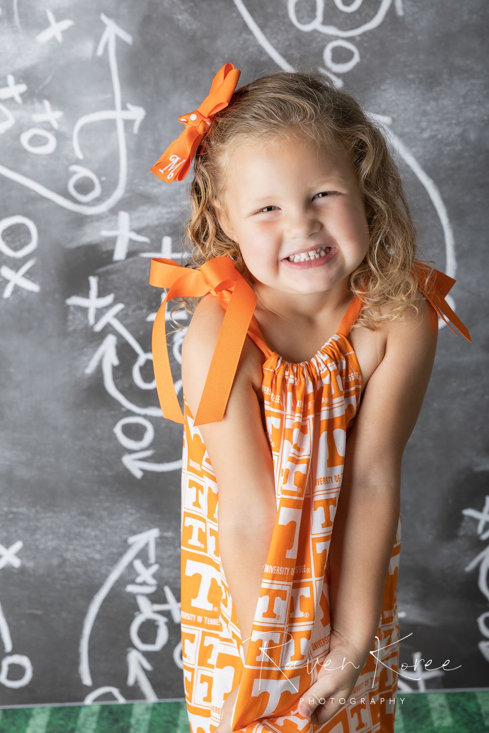 Girl in University of Tennessee dress posing for football themed portraits
