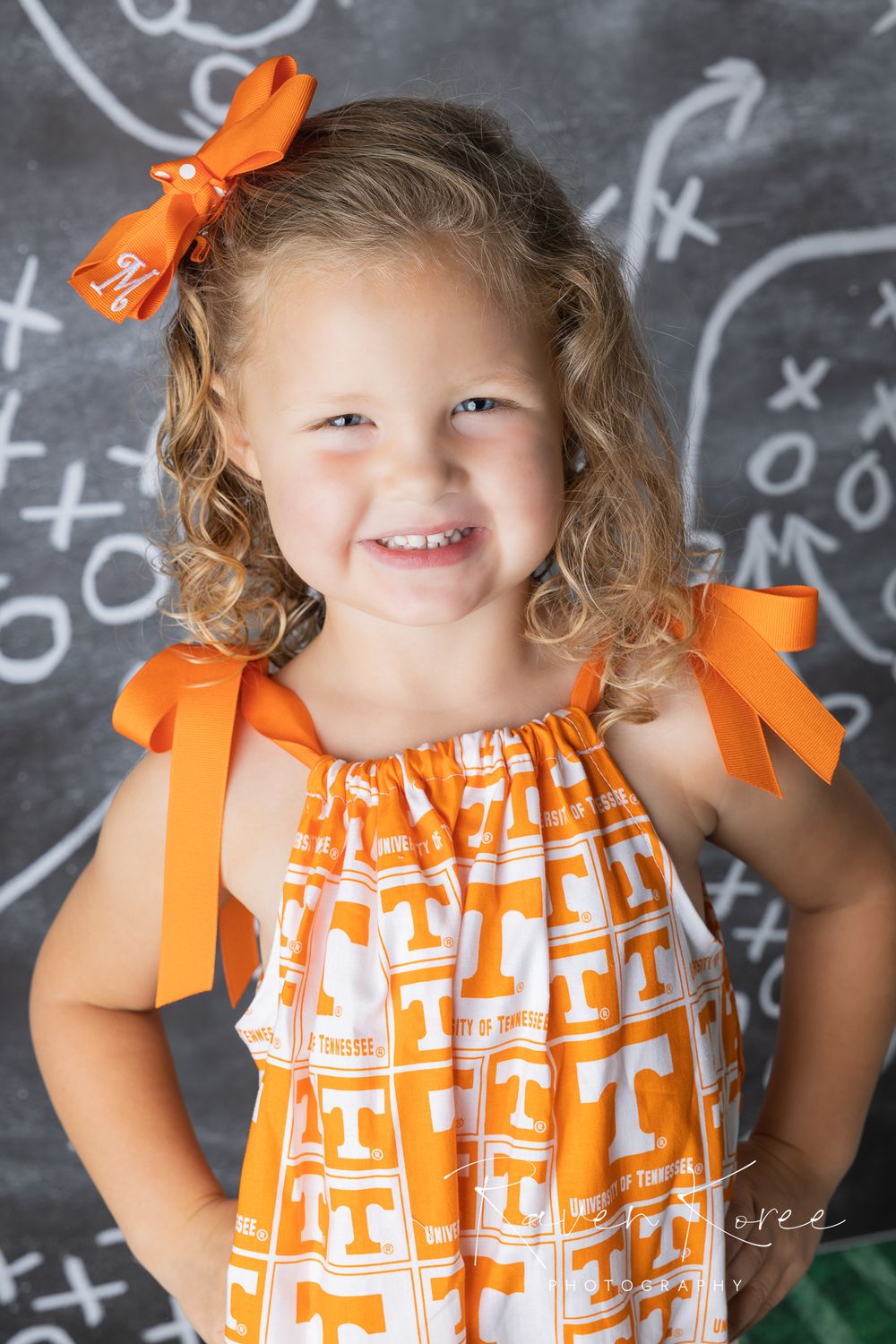 Girl in University of Tennessee dress posing for football themed portraits