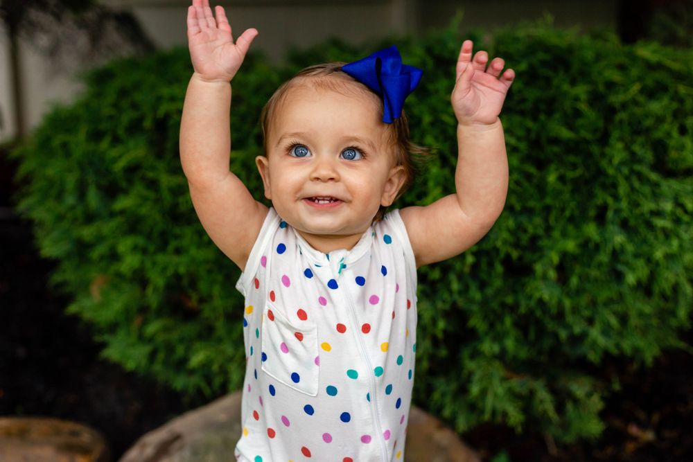 little girl throwing her arms in the air