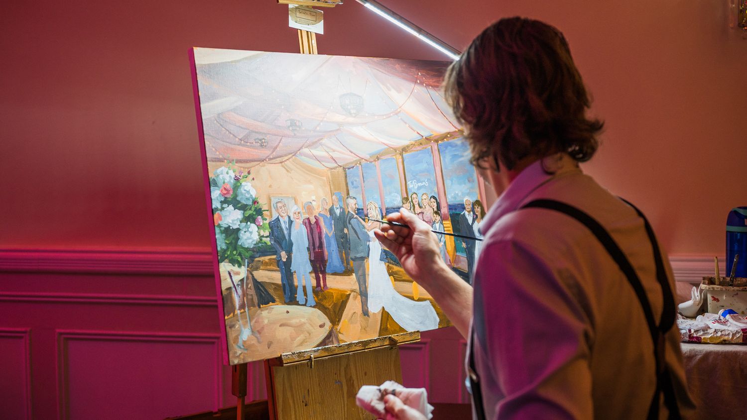 Artist capturing the wedding on canvas, adding a touch of live artistry. Live wedding painter