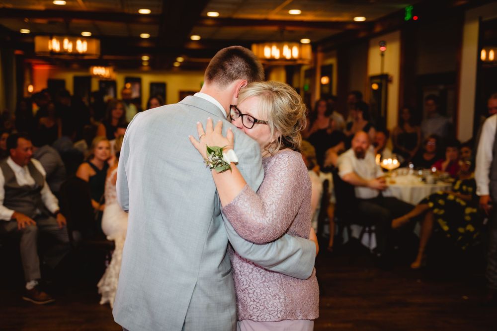 Special dance moment between guests in formal attire at wedding reception.