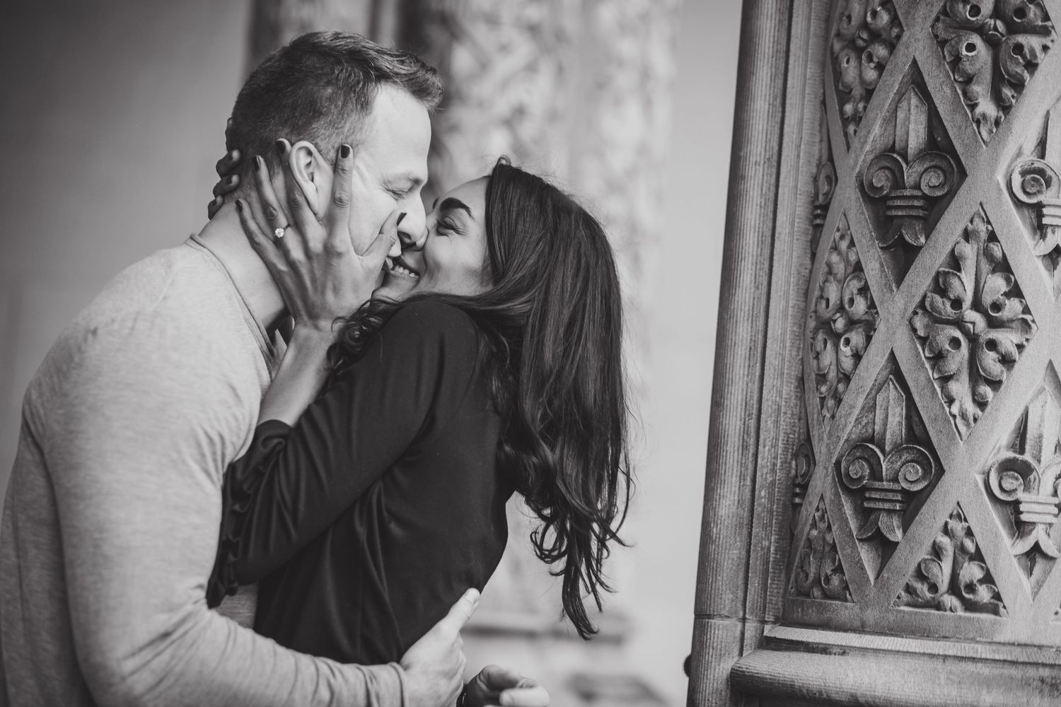 Intimate black and white portrait of a romantic couple sharing a tender moment.