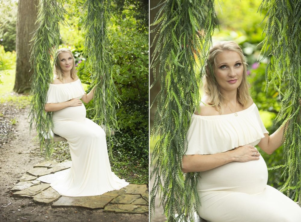Maternity portraits under weeping willow tree in flowing white dress.
