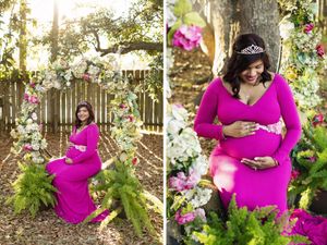 Maternity portraits in a garden setting with floral archway featuring bright magenta dress.