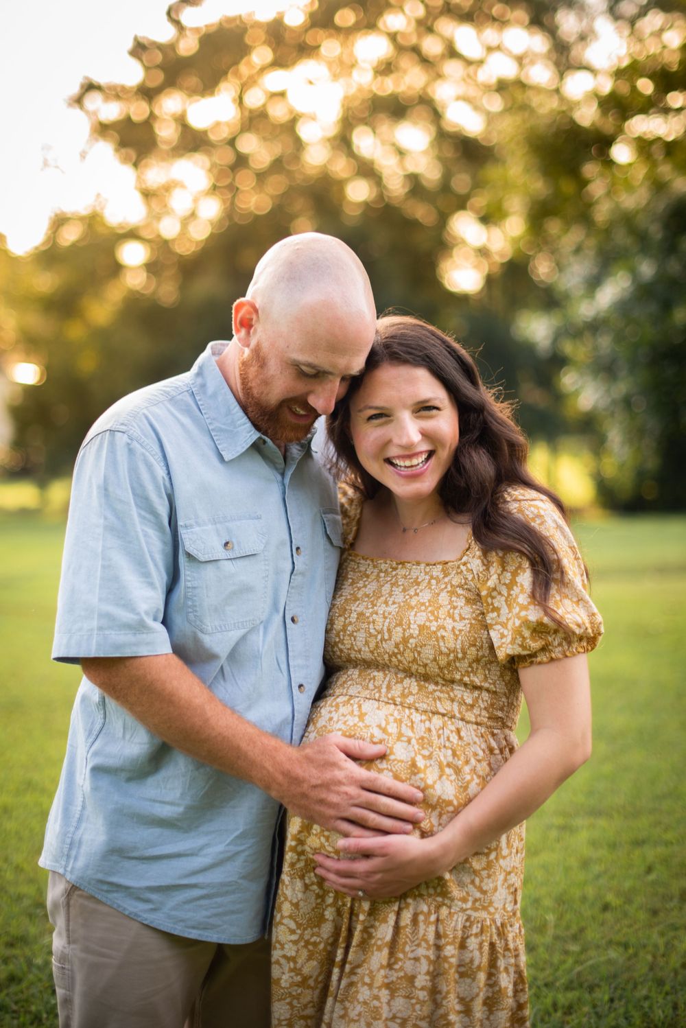 Husband looking down at his pregnant wife's stomach