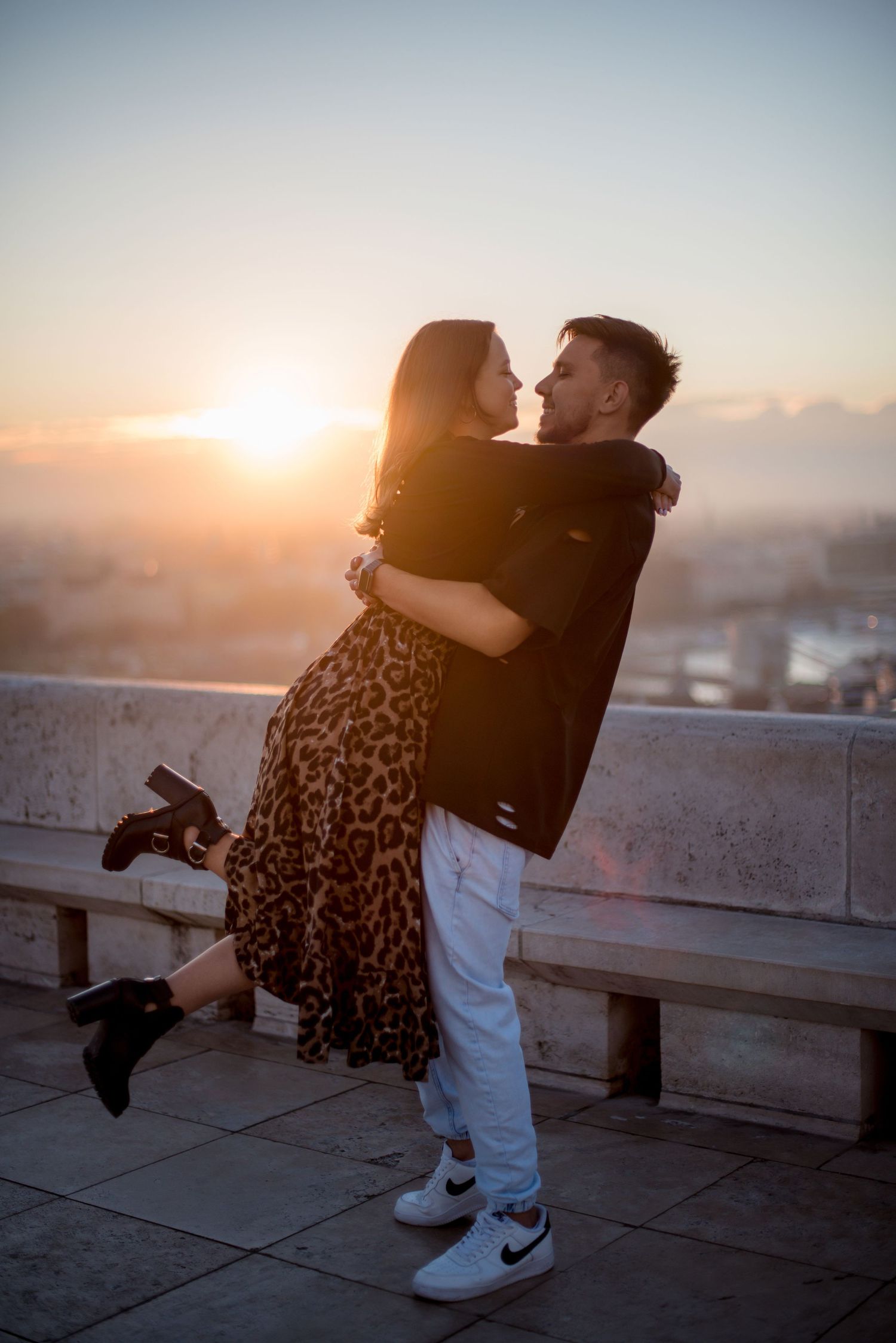 couple embracing each other during sunrise at fisherman's bastion