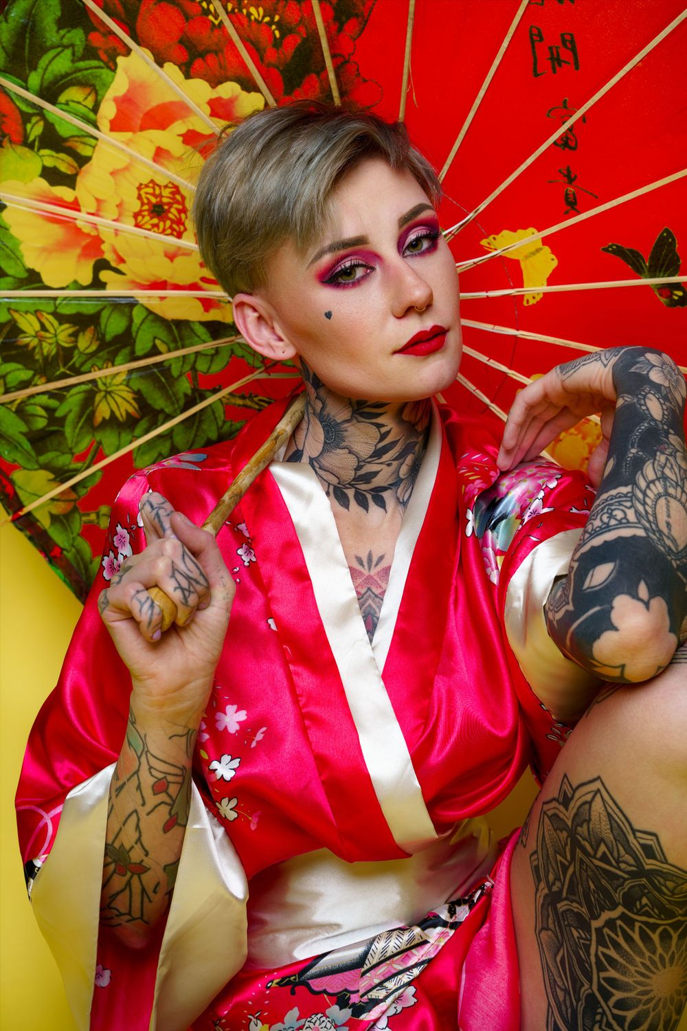 Stylized portrait with red Japanese umbrella and pink kimono against vibrant background.