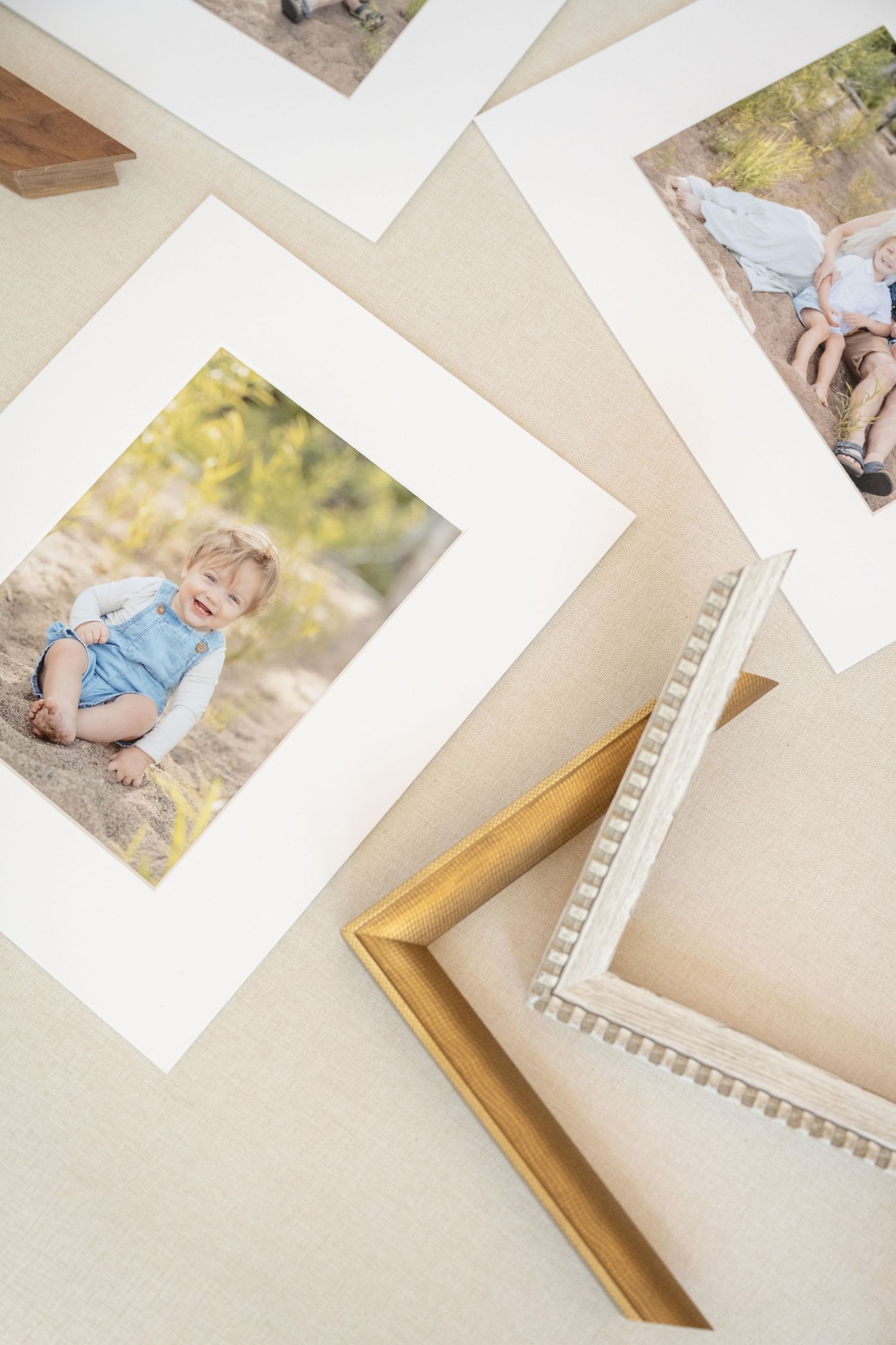 Matted prints and heirloom fabric print box by Jagger Rose Photography showing in home lifestyle newborn portraits in Hudson, Wisconsin