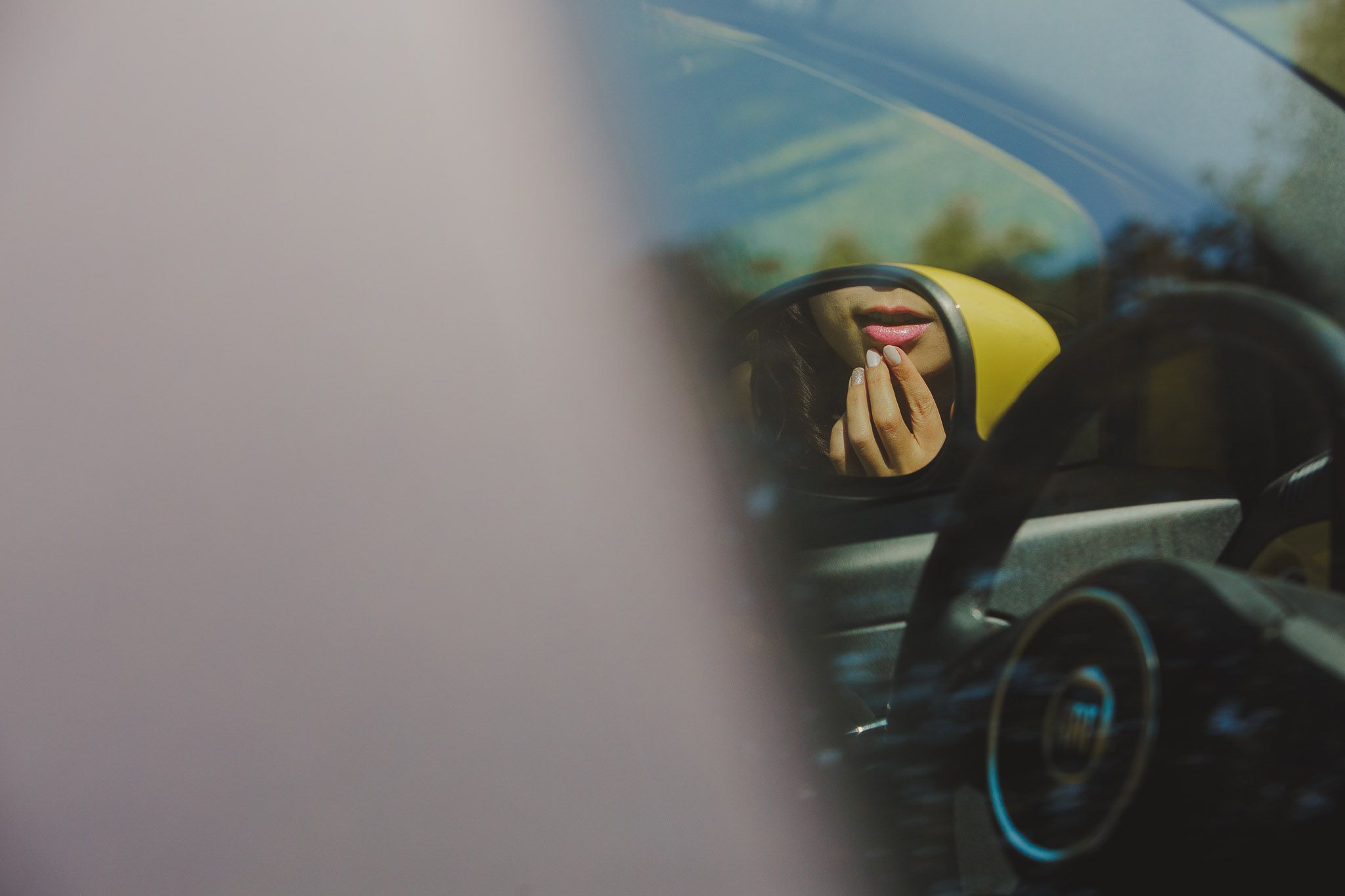 Artistic close-up shot through car window with yellow details.