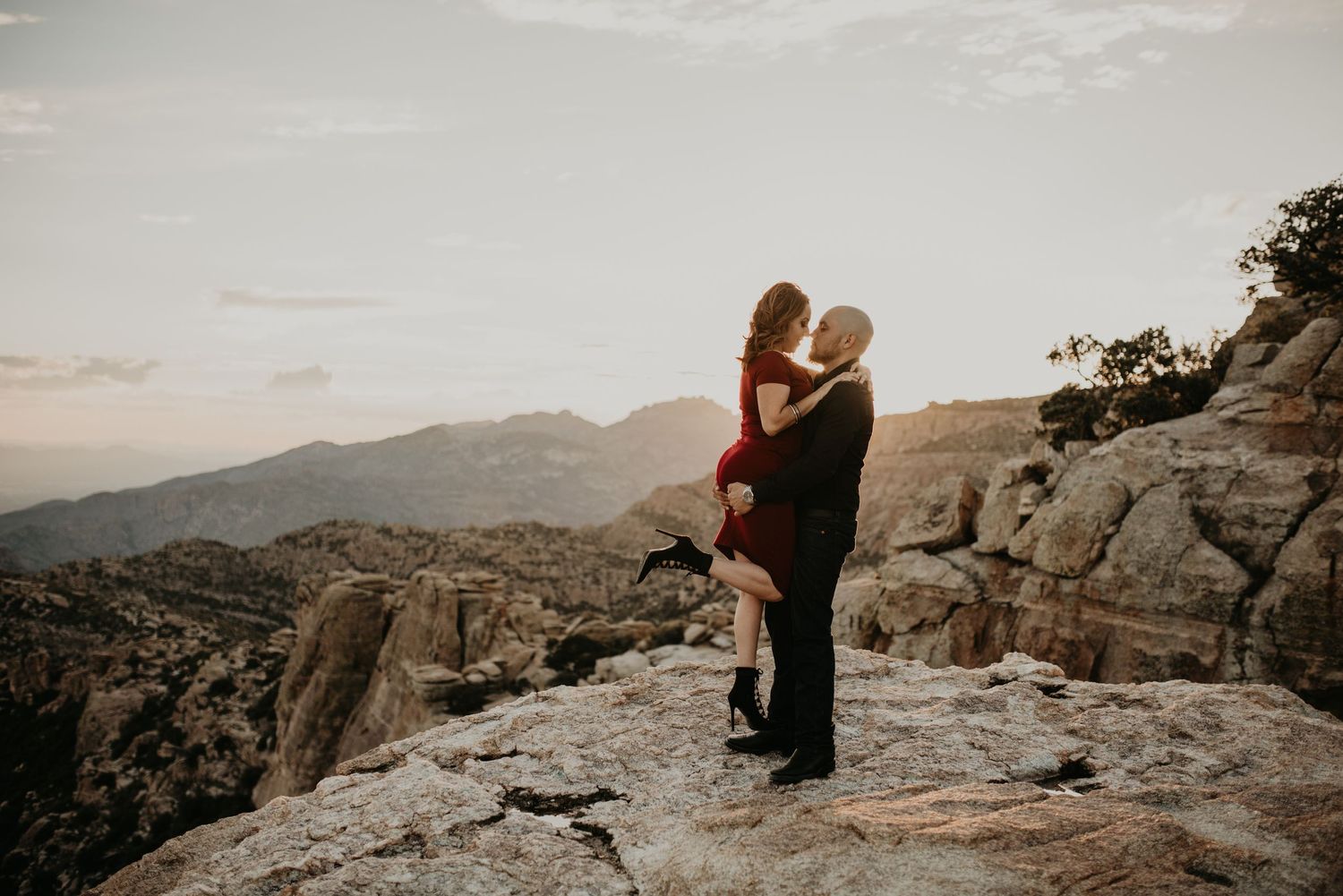 Scenic mountain landscape view at sunset with rocky outcrops and distant peaks.