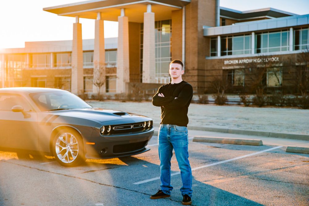 Broken Arrow High School Senior Photo Session in front of Broken Arrow high school with sunrise and car
