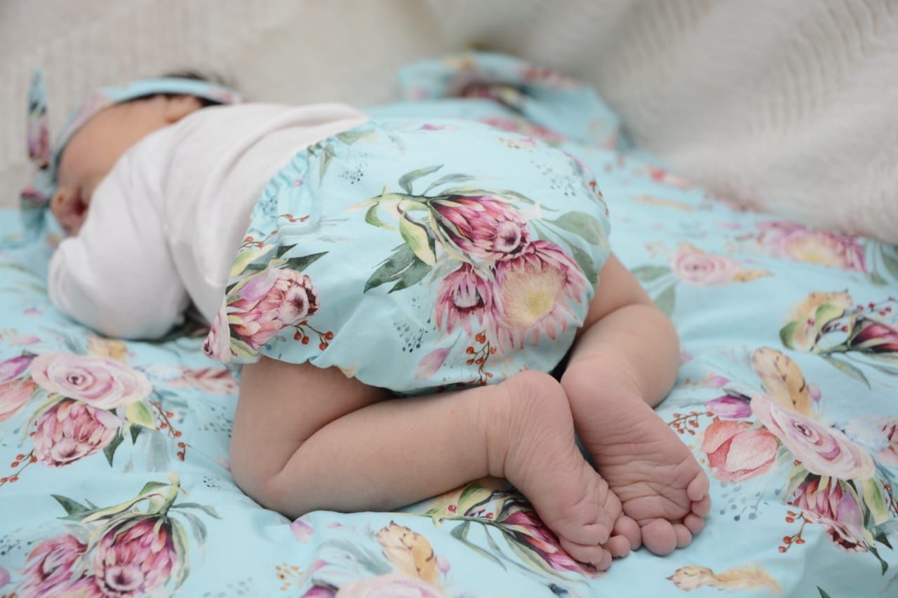 Soft floral baby blanket with delicate pattern shown in detail.