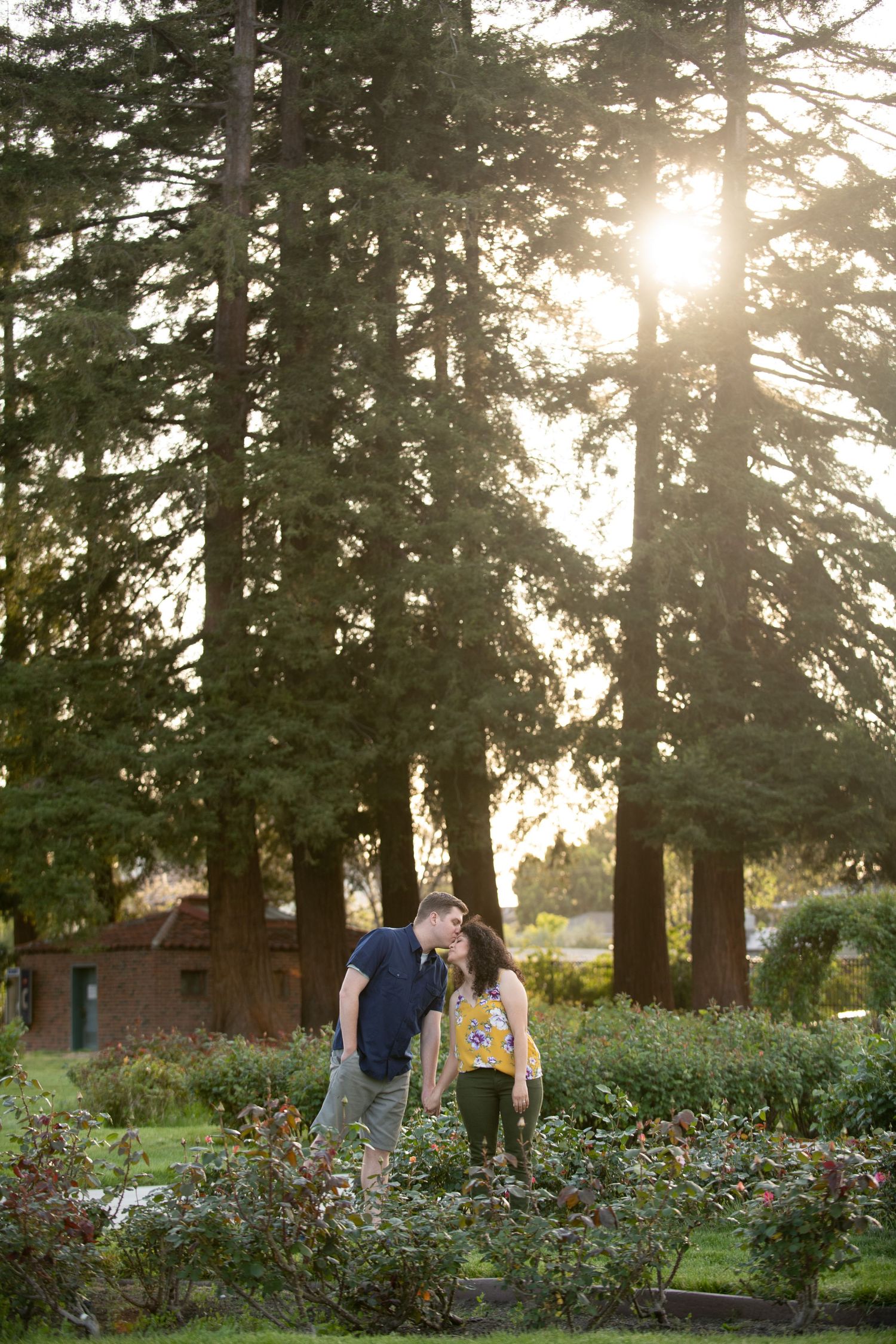 Couple leaning in toward each other, The Municipal Rose Garden in San Jose, CA