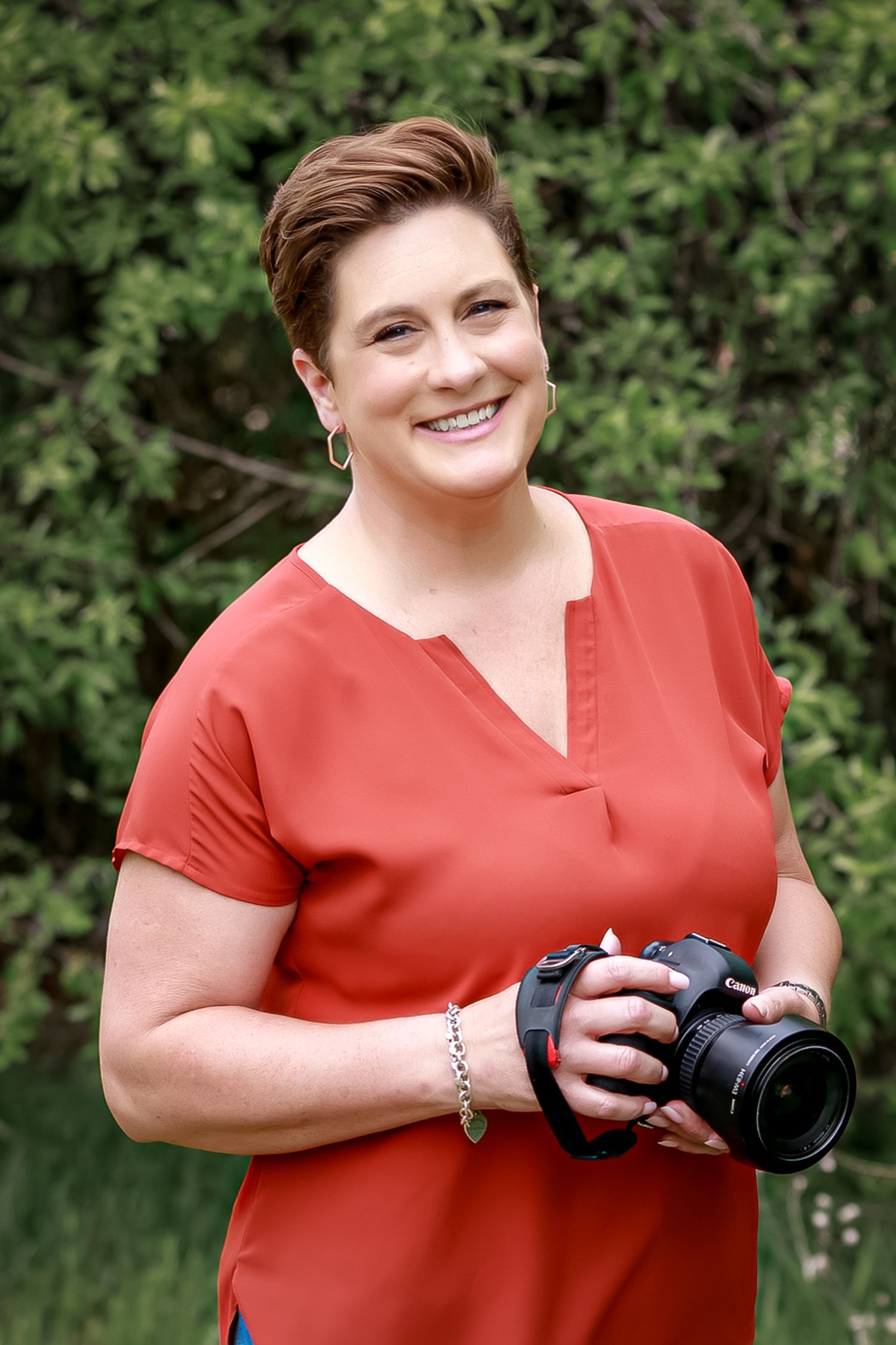 woman photographer wearing orange with camera granbury Weatherford Cleburne