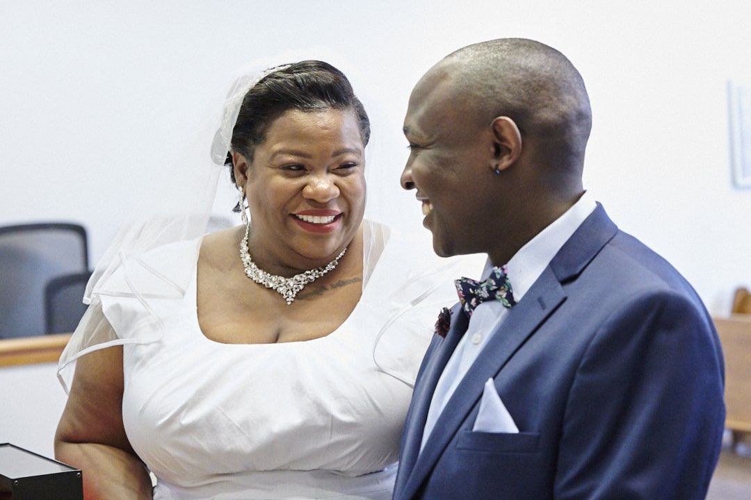 Bride and groom giggling and smiling at each other at Redmond Courthouse in Redmond, WA